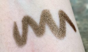gold makeup swatch on arm