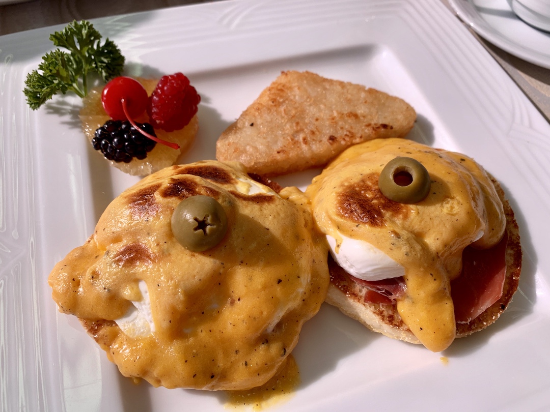 Eggs Benedict with poached eggs and hollandaise sauce