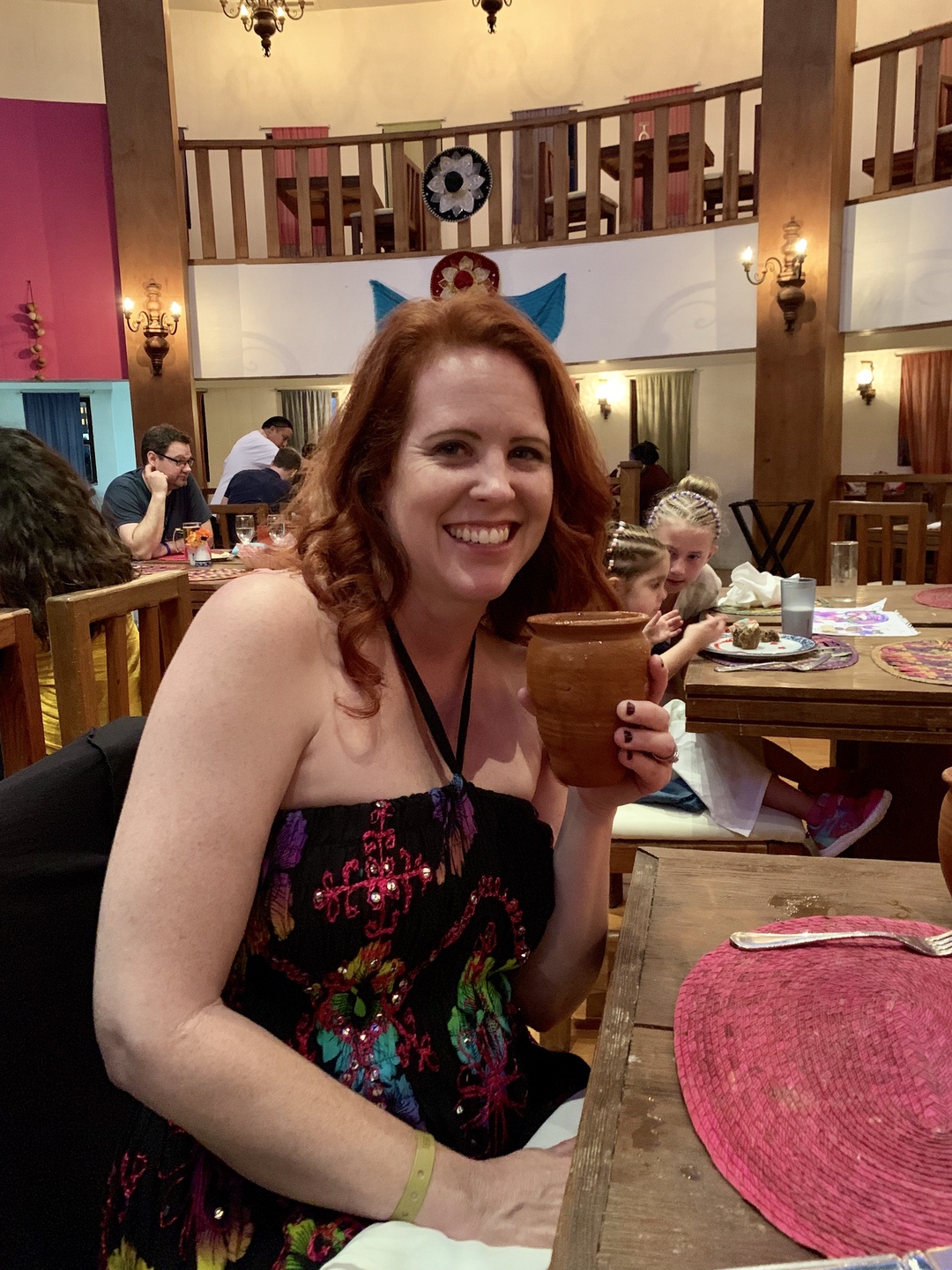 woman holding drink in restaurant