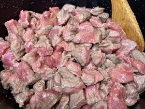 seasoned steak cooking in pot
