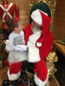 santa claus with little girl on lap