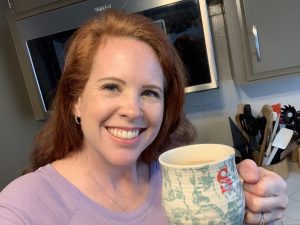 A woman holding a cup of coffee