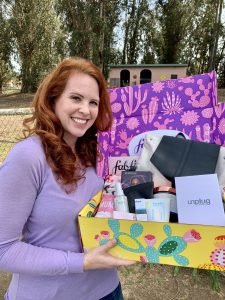 A woman holding a subscription box