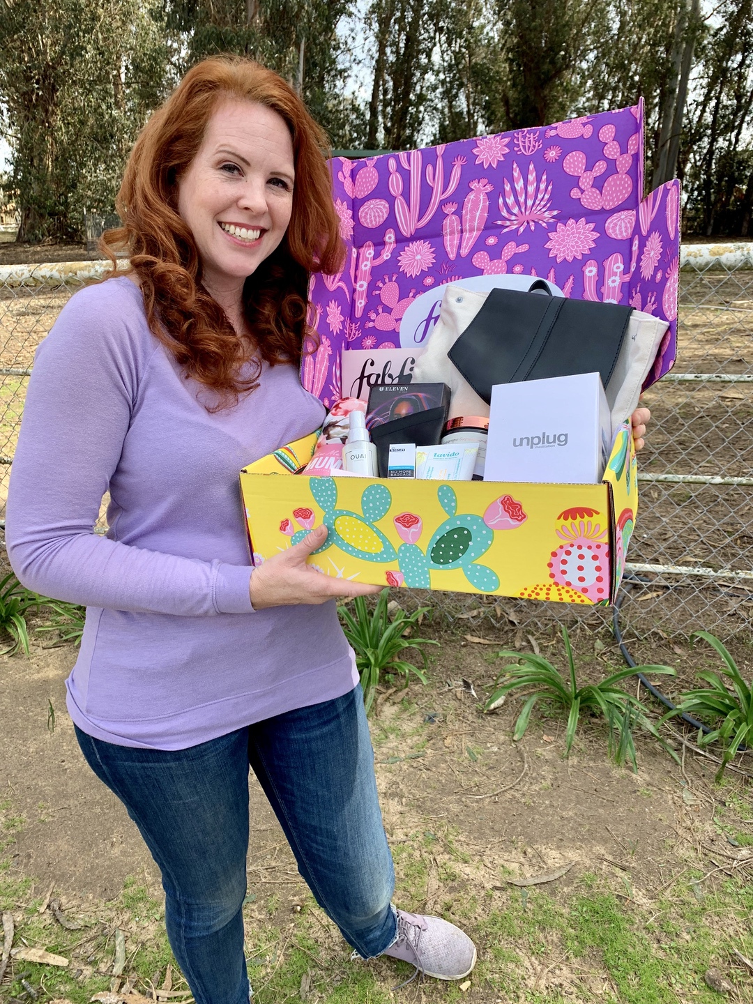 A woman holding a FabFitFun subscription box