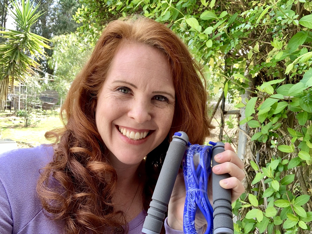 a woman holding a jump rope