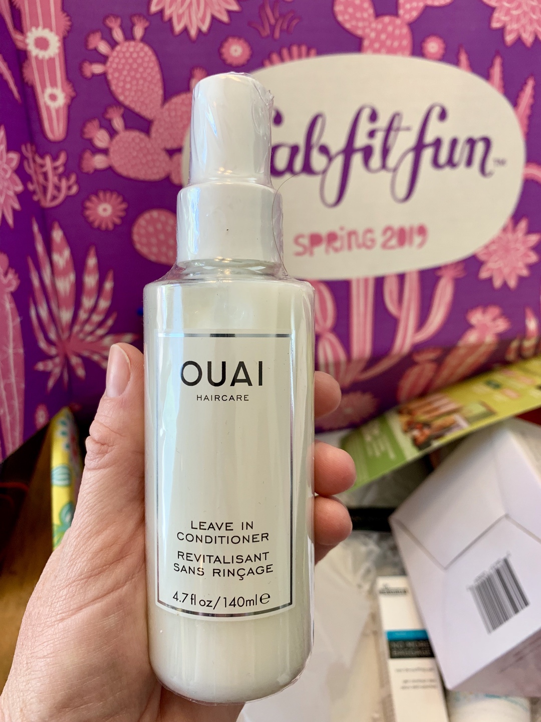 hand holding a bottle of beauty product