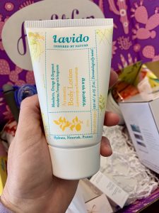 hand holding a tube of beauty product