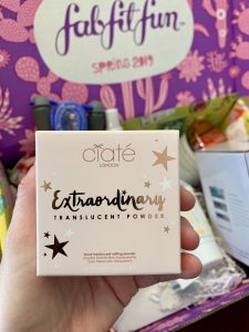 hand holding a box of makeup