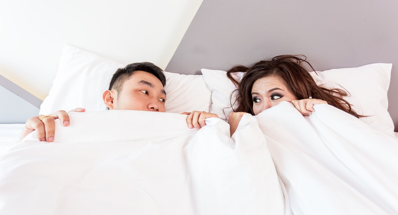 Man and woman in bed under covers