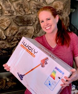 woman holding box with vacuum cleaner