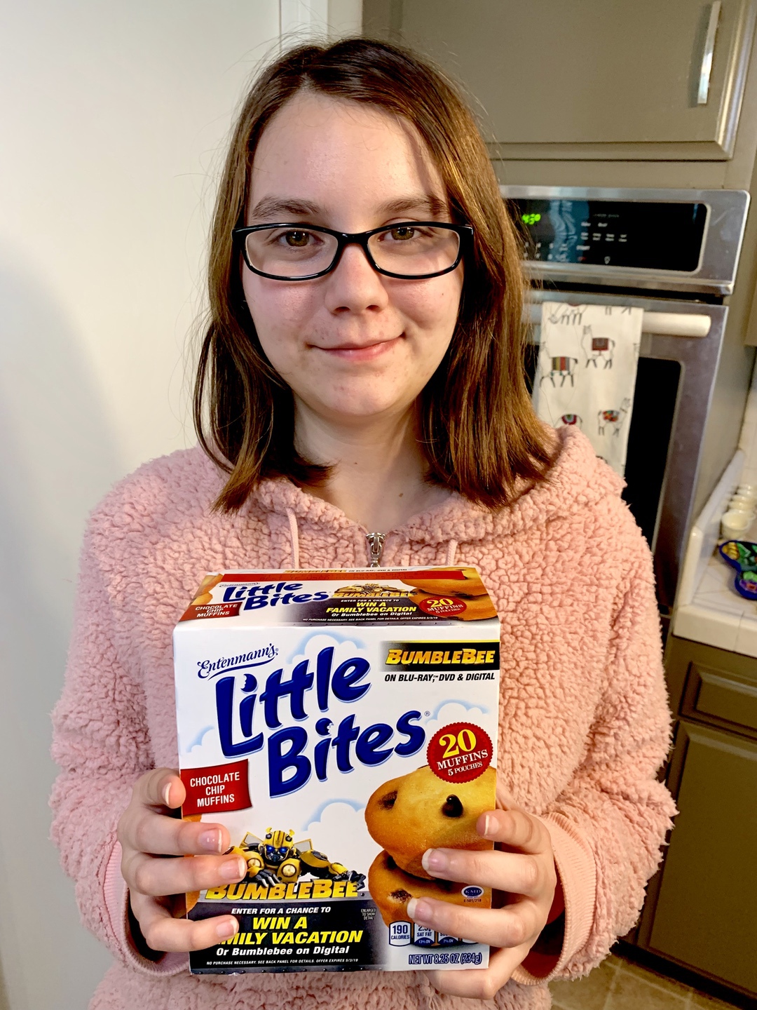 Girl holding box of Entenmann's Little Bites Muffins