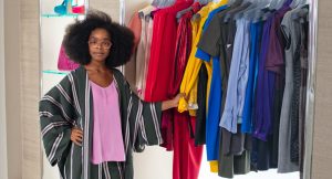 girl with glasses in closet with clothes