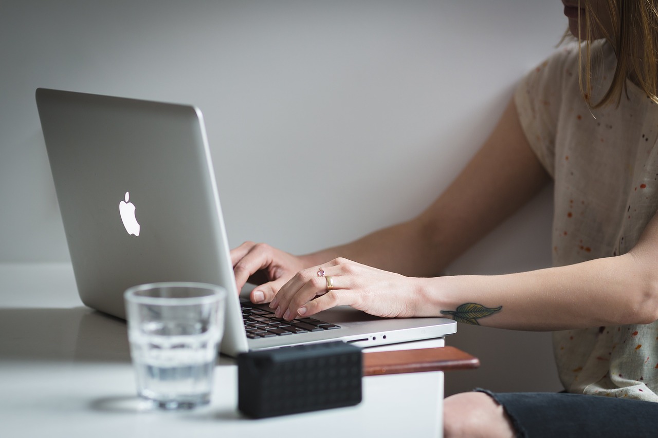 Woman at laptop typing