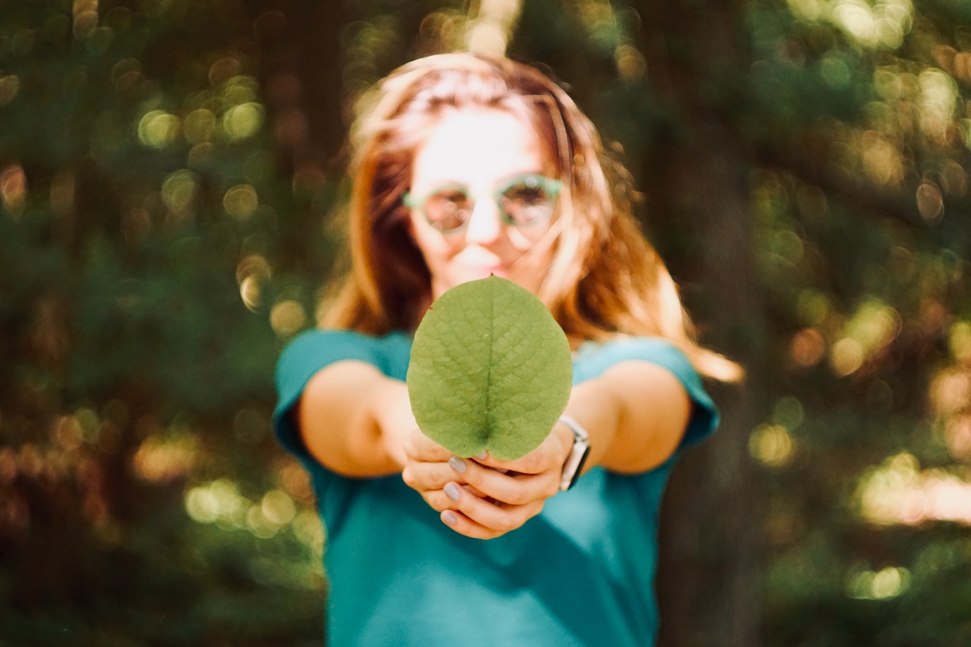 girl holding leaf