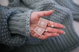 hand holding earrings