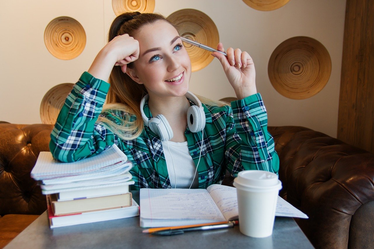 student with books and coffee
