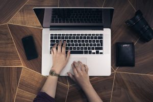 Hands Typing on Laptop
