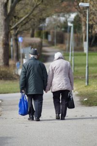 older adults walking and holding hands