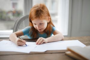child with book homeschooling