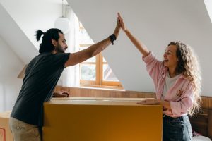 high five over packed boxes from moving