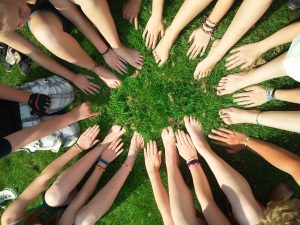 hands feet in grass