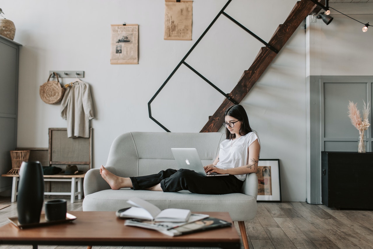 woman on couch with laptop