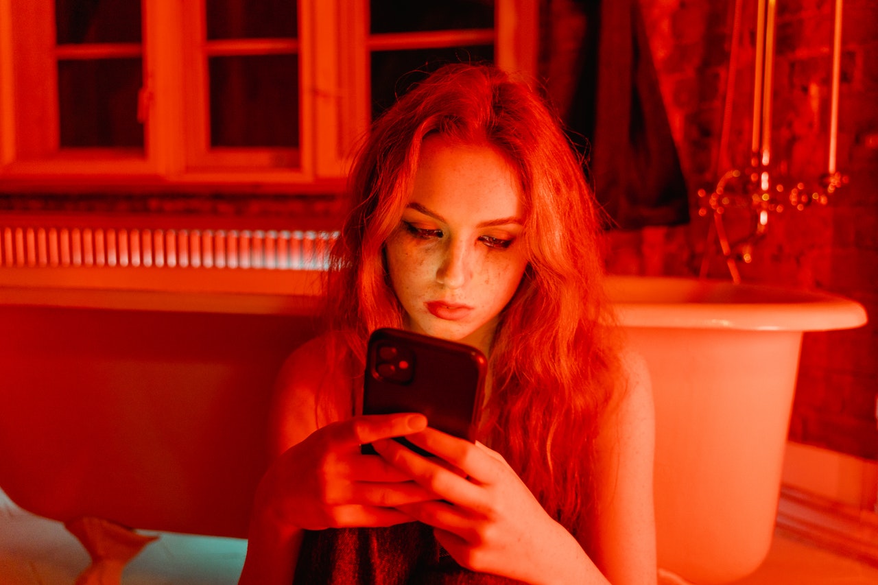 Person with phone and red background