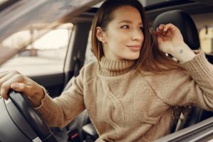 woman behind wheel in car
