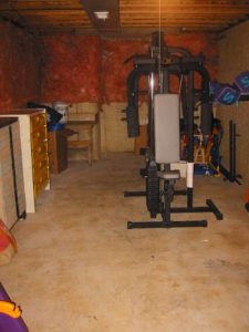 A basement with weight equipment