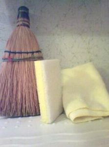 A close up of a broom and sponge