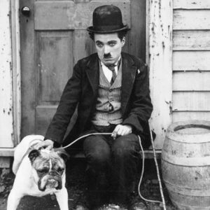 Charlie Chaplin holding a dog