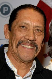 A close up of Danny Trejo smiling for the camera