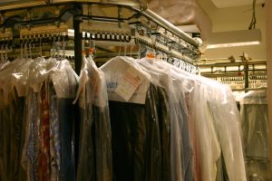 dry cleaning hanging in cleaners
