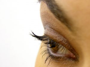 A close up of a woman's eyelash and eyelid
