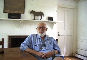 An old man sitting in a dining room