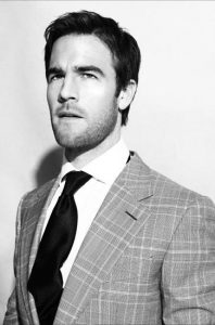 James Van Der Beek wearing a suit and tie looking at the camera