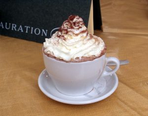 whipped cream on hot cocoa in cup