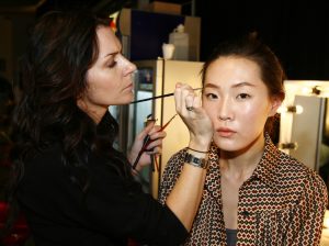 A woman applying makeup