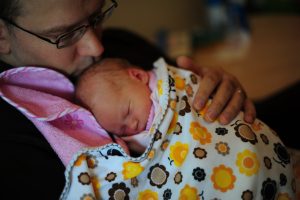a man holding a baby