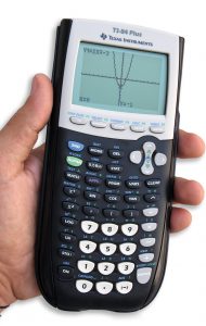 A hand holding a graphing calculator