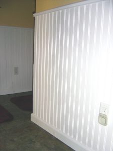 A wall with white panelling