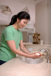 a woman standing at a sink