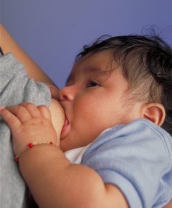 A hand holding a baby