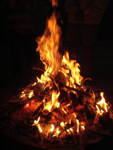 A large fire in a dark room