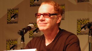 Danny Elfman holding a wine glass