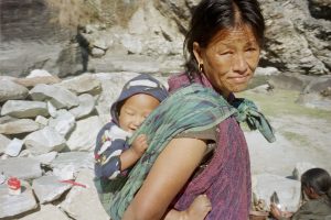 A person carrying a baby on their back