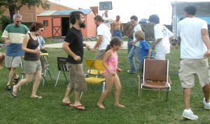A group of people playing a game in a yard