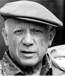 Pablo Picasso wearing a black hat