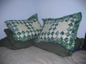 A bed with a green blanket