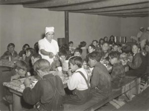 A group of kids eating school lunch